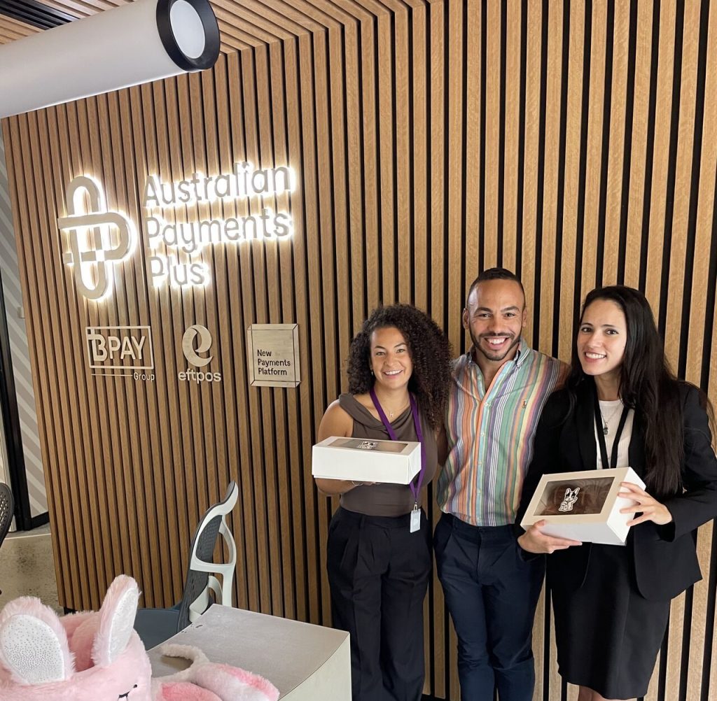Picture of Arron and two doris temps in reception, holding boxes of cupcakes